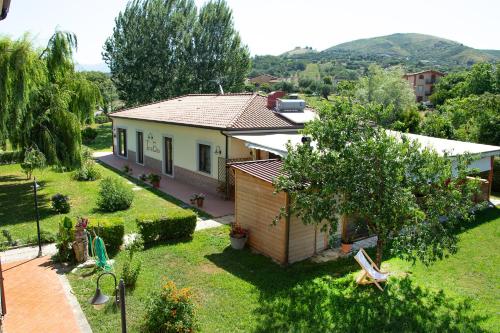 a small house with a garden and a house at Agriturismo Terra Di Elea azienda agricola di Raimondo MIchela in Ascea