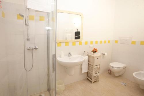 a bathroom with a sink and a shower and a toilet at Villa Rosato in Selva di Fasano