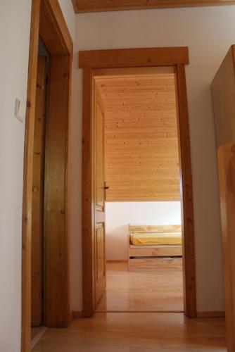 an open door to a bedroom with a bed at Roubenka Zlatá Olešnice in Zlatá Olešnice