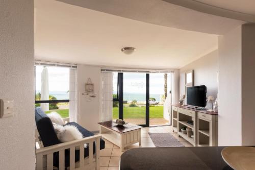 a living room with a couch and a television at SantoSea in Mossel Bay