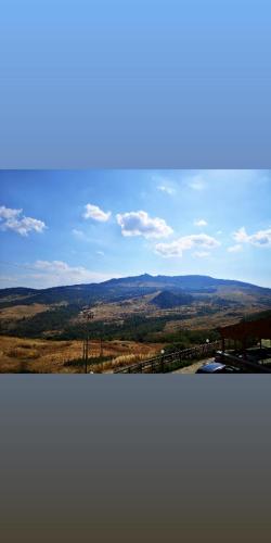 a view of a field with mountains in the distance at MonteSoprano Agriturismo - Resort - Spa - Gym -Camping - Suite in Capizzi