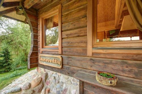 a log cabin with a window on the wall at Prie Klykio in Utena