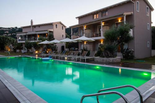 a swimming pool in front of a building at Summer Dream Lefkas in Lefkada Town