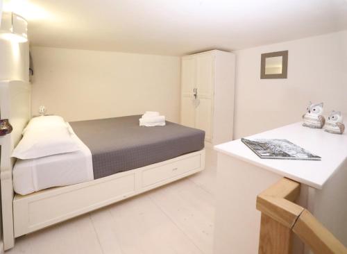a small bedroom with a bed and a counter at Villa Rosato in Selva di Fasano