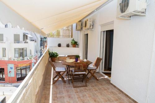a balcony with a table and chairs on it at Acropolis,Historic center Apartment-update in Athens