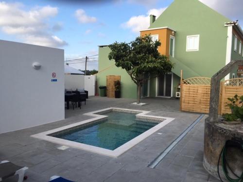 a backyard with a swimming pool and a house at Casinha Verde in Nadadouro