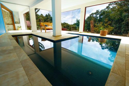 an infinity pool in the middle of a house at Pousada Ahavanoah in Monte Verde