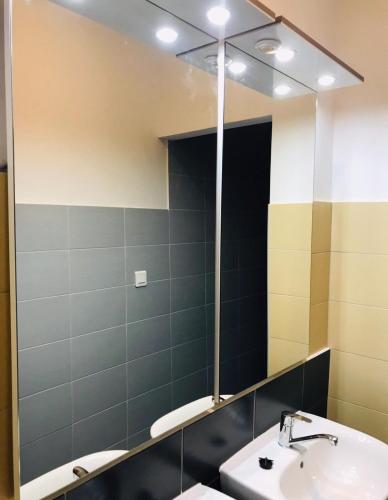 a bathroom with a mirror and a sink at Bowling Hostel in Split