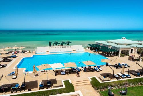 an aerial view of a resort with a pool and the ocean at Ulysse Thalasso & Spa - All Inclusive in Houmt Souk