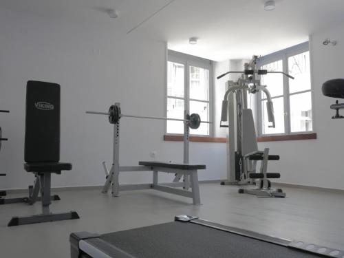 a room with a gym with machines and a treadmill at Bratsera Boutique Hotel in Hydra