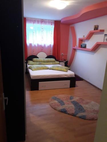 a bedroom with two beds and a rug on the floor at Casa Ade in Călimăneşti