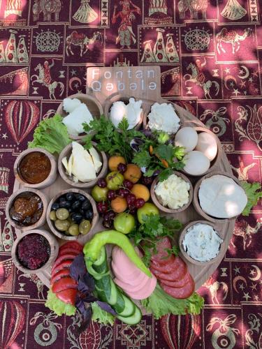 a tray of different types of food on a table at Qafqaz Fountain Villa in Gabala