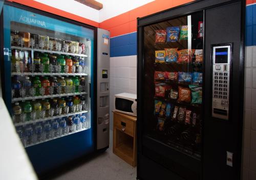 a soda vending machine in a room with drinks at Charlroy Motel in Seaside Park