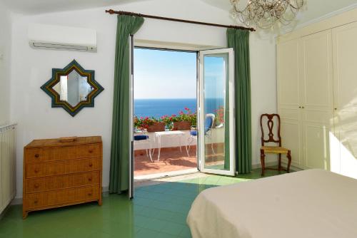 a bedroom with a bed and a view of the ocean at Aglaia Luxury Seaview Villa in Ischia