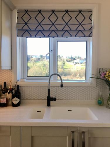 a kitchen with a sink and a window at The Cornish Retreat in Bude