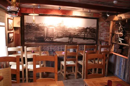 a dining room with a large painting on the wall at Bergstadens Hotel & Spa in Røros