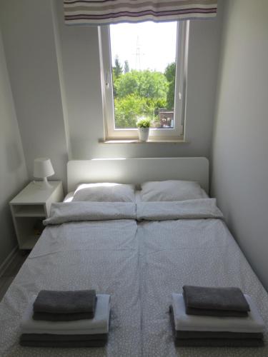 a bedroom with two beds and a window at Apartament Kamelia in Sopot
