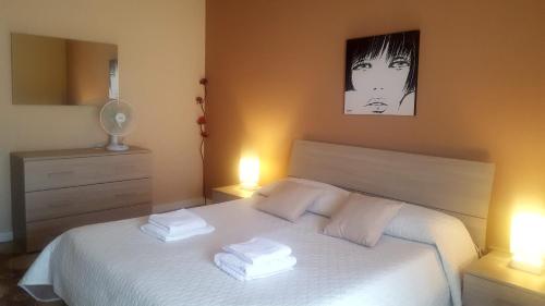 En eller flere senge i et værelse på Appartamento Etna