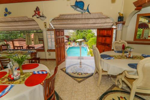a living room with a table and chairs and a pool at Rayon Hotel in Negril