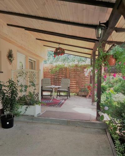 a patio with a table and chairs in a backyard at Pokoje Gościnne Gazda in Polanica-Zdrój