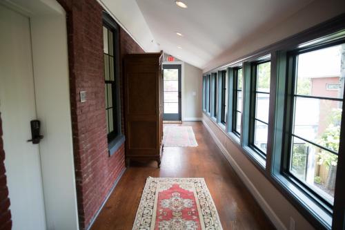 an empty hallway with windows and a rug at The Germantown Inn in Nashville