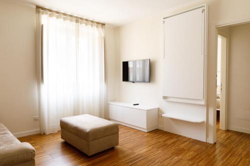 a living room with a couch and a chair and a television at I VICOLI Exclusive Apartments in Fondi