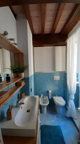 a bathroom with a white sink and a toilet at il nido dell'arancio in Carrara
