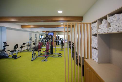 a gym with a green floor and tread machines at Hotel Miracorgo in Vila Real