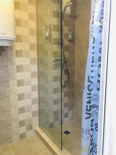 a shower in a bathroom with a glass door at Дача у моря in Vapnyarka