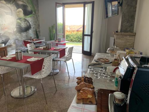 a restaurant with tables and chairs with food on them at Villa Cuore in Tavernerio