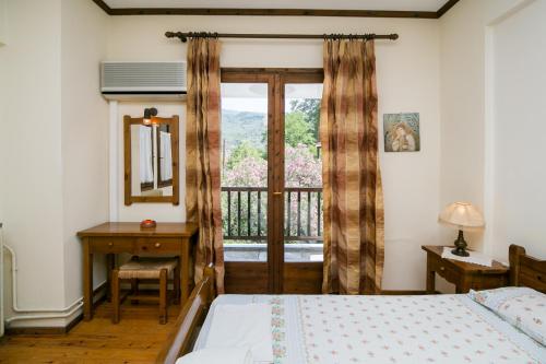 sypialnia z łóżkiem, oknem i biurkiem w obiekcie Apartments Hotel Magani w mieście Kala Nera