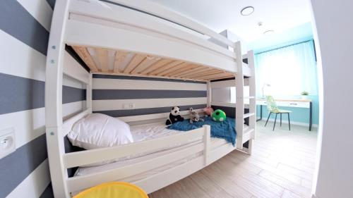 a bunk bed in a childs bedroom with striped walls at Baltic Pearl in Ustka