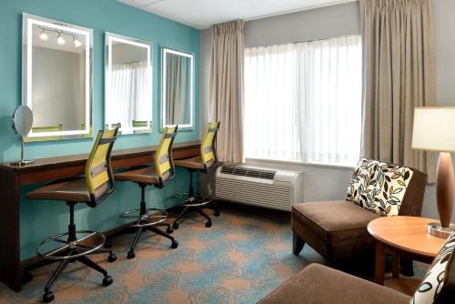 a hotel room with a desk and chairs at The Inn at Saint Mary's in South Bend
