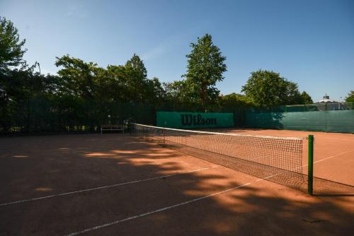 a tennis court with a net in the middle at Holiday Resorts in Balatonszárszó