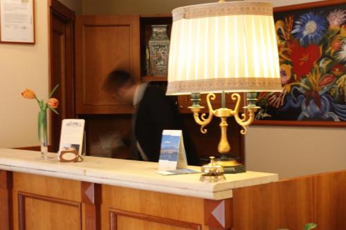 a lamp sitting on top of a reception desk at Hotel Europa in Naples