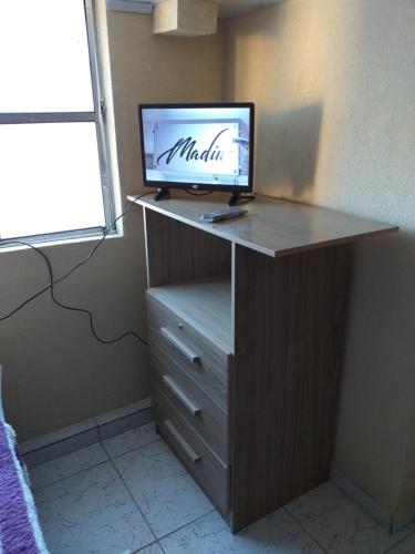 a desk with a computer monitor on top of it at Hostel Aprisco São Paulo in São Paulo
