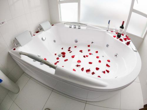 a bath tub with red hearts on it at Hotel Estación Sabana in Zipaquirá