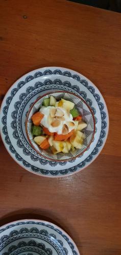 a bowl of vegetables on a wooden table at Hidden Cove Eco Retreat in Luganville