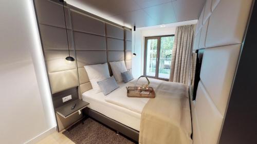 a small room with a bed and a window at White Pearl Apartment 1.12 in Timmendorfer Strand
