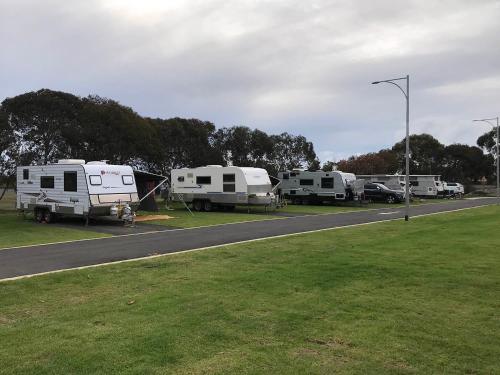 a group of rvs parked on the side of a road at Riverside Cabin Park in Eaton