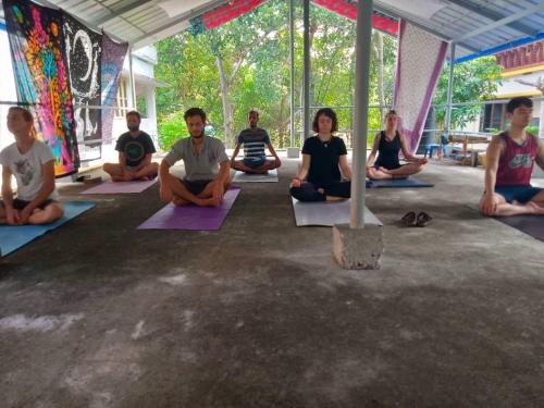 a group of people sitting in a yoga class at Hope Hostels, Varkala - Helipad in Varkala