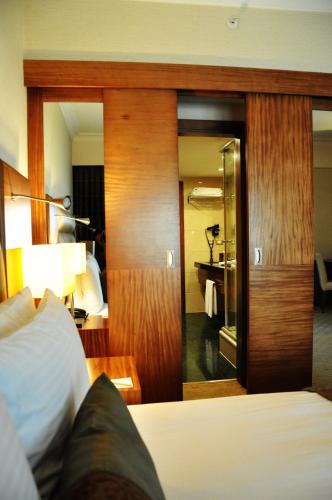 a hotel room with a bed and a bedroom at Mövenpick Hotel Izmir in Izmir