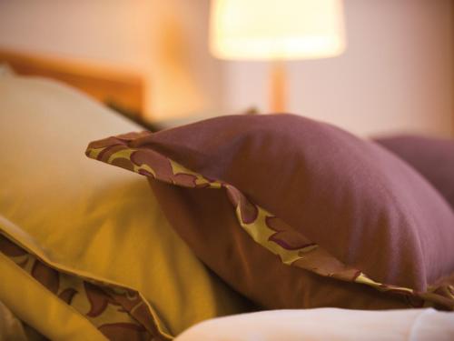 a pillow sitting on top of a couch at A-ROSA Strandidyll Heringsdorf in Heringsdorf