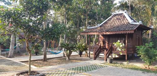 a small shack with a playground in a park at Anugrah Borobudur in Borobudur
