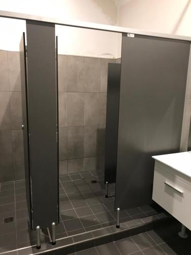 a bathroom with a shower with a glass door at Garden Hotel in Dubbo