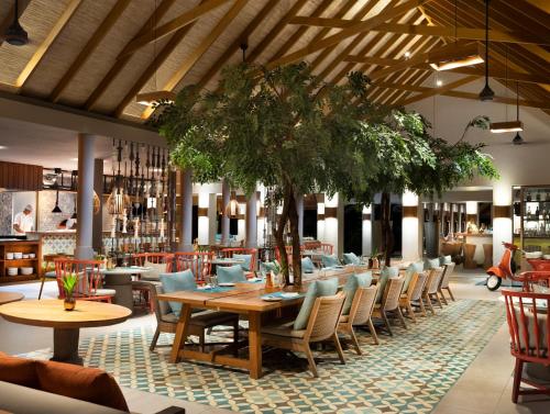 a dining room with a table and chairs at Vakkaru Maldives in Baa Atoll