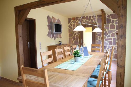 a dining room with a wooden table and chairs at Ferienhaus Landeskrone in Dresden