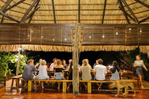 a group of people sitting at a table at Buena Vista Surf Club in Playa Maderas