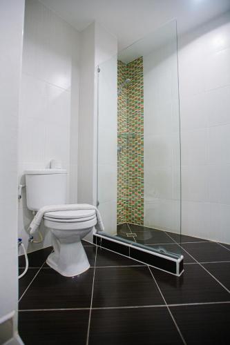 a bathroom with a toilet and a glass shower at Best Western Royal Buriram in Buriram