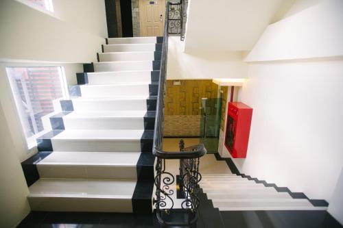 a stairway with a black and white staircase with a chair at Best Western Royal Buriram in Buriram